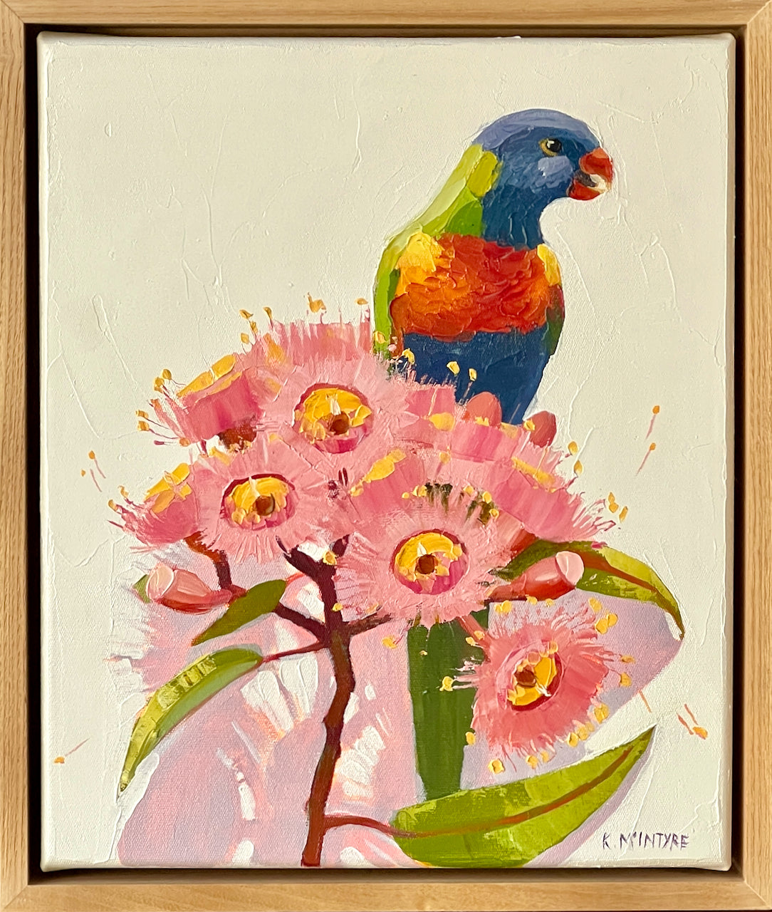 Colorful parrot perched on pink flowers with a wooden frame. Rainbow lorikeet original artwork by Kirsty McIntyre, Australian artist