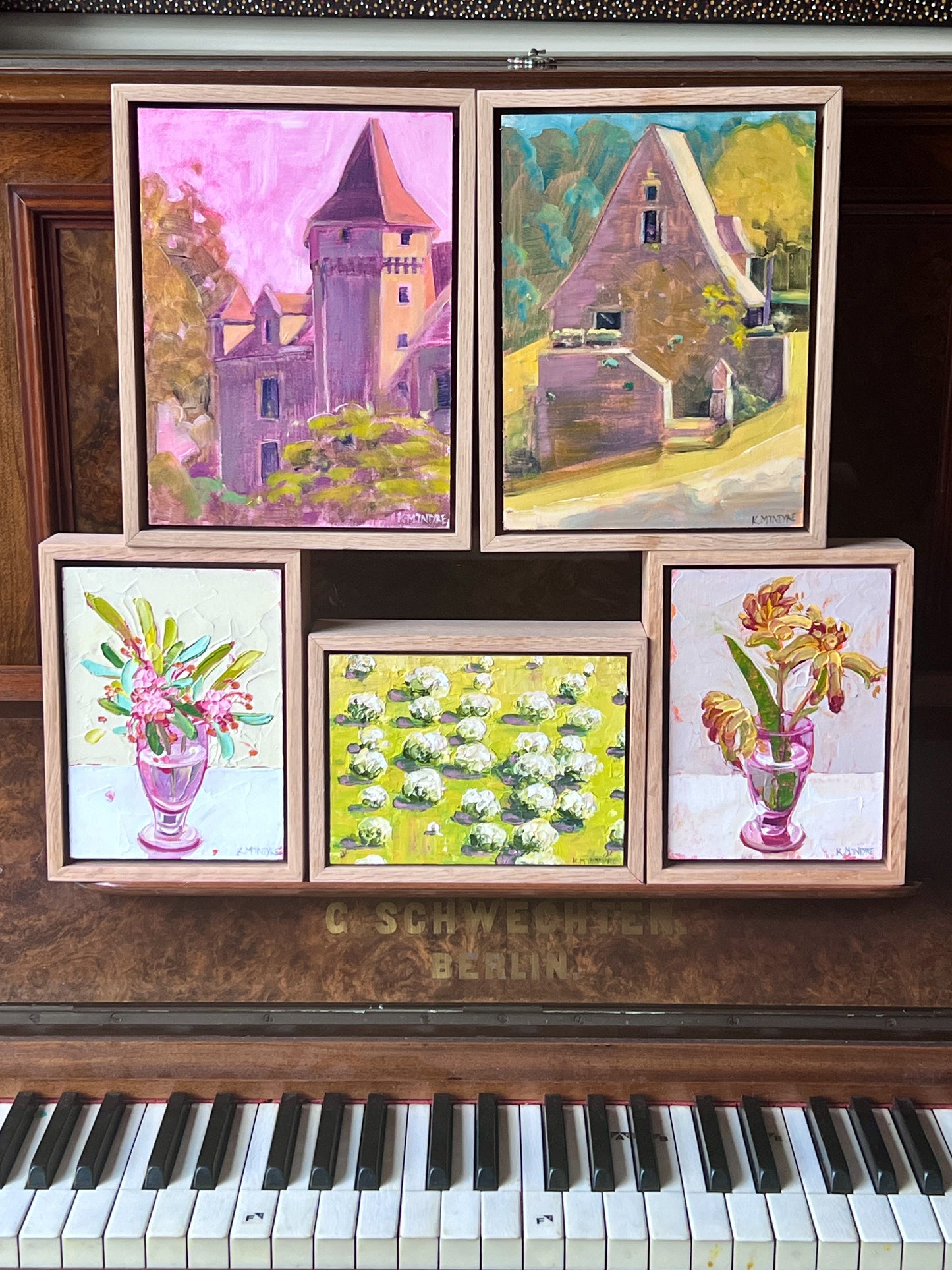 Framed paintings on a vintage piano