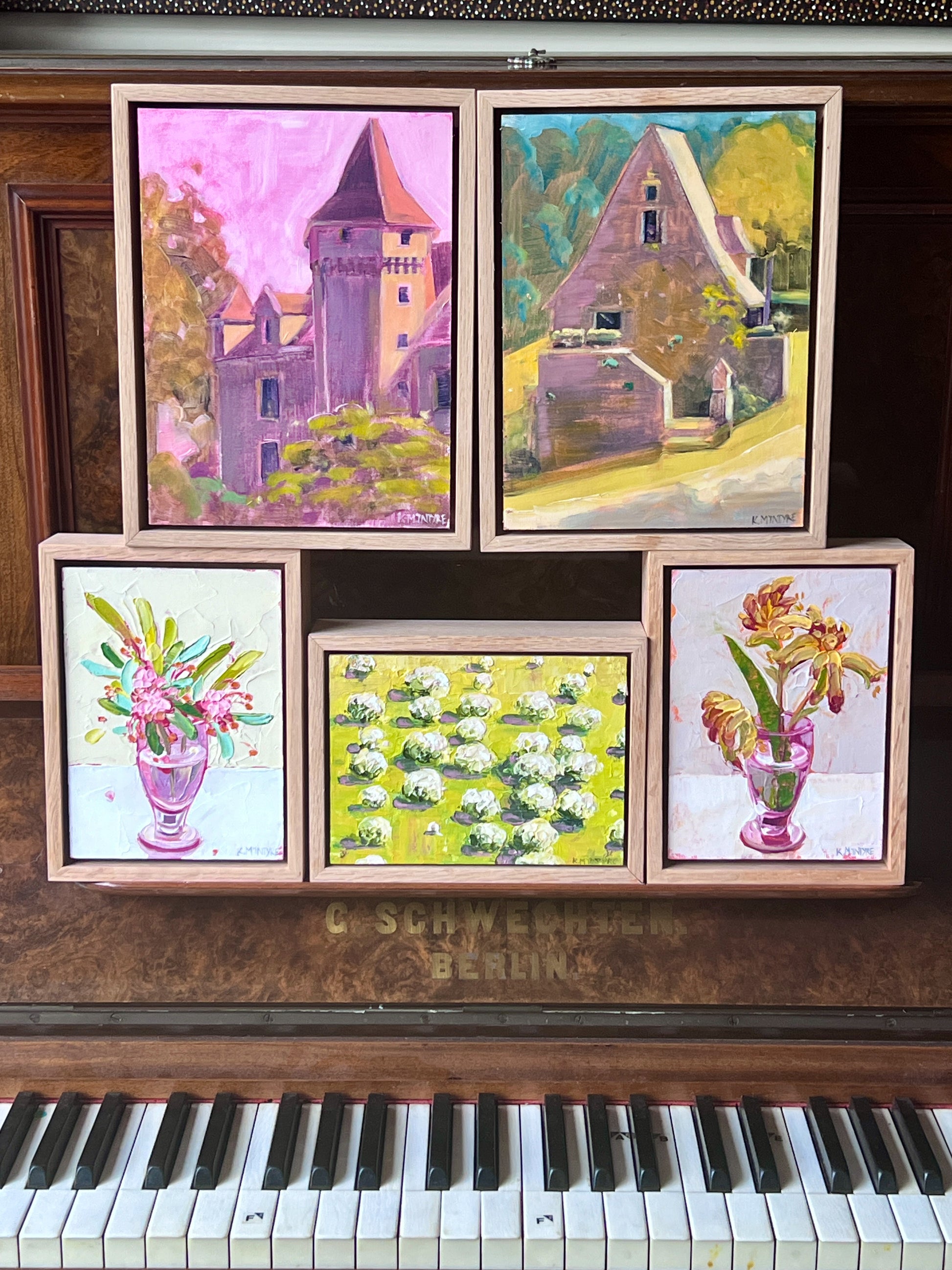 Framed paintings on a vintage piano
