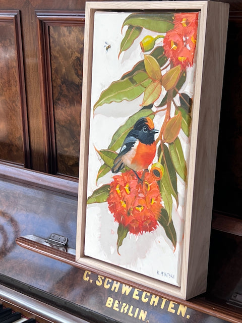 Red capped robin, scarlet blossom.