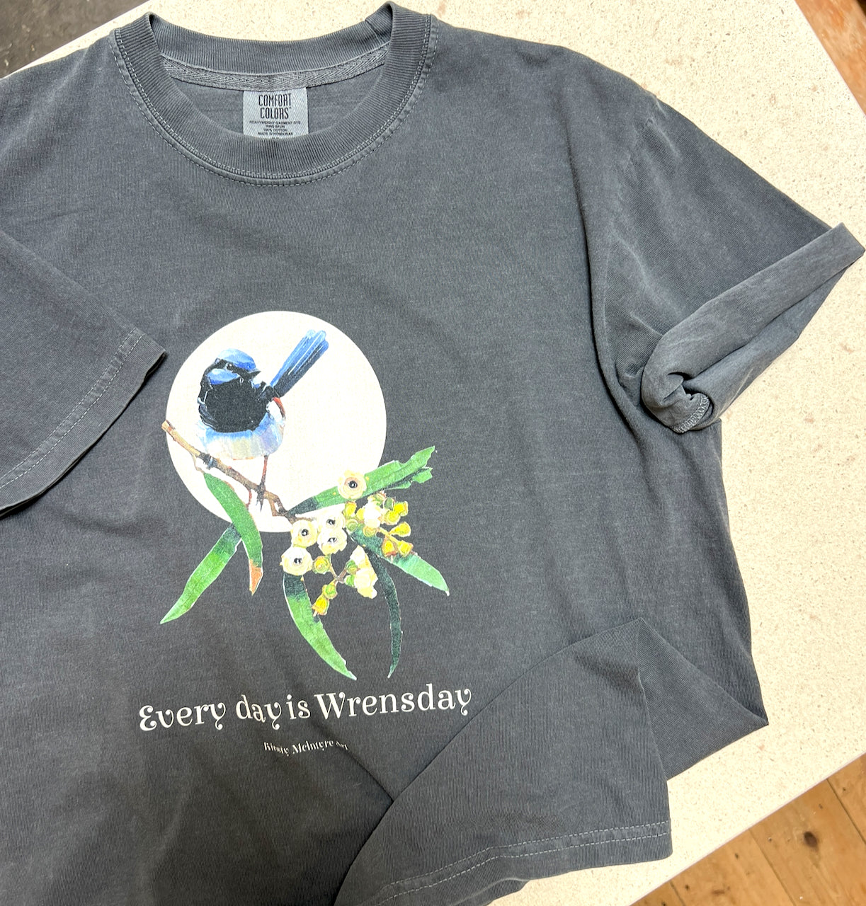 comfort colours tshirt with an "Every day is wrensday" original art design by kirsty mcintyre art with a blue wren and gum blossom