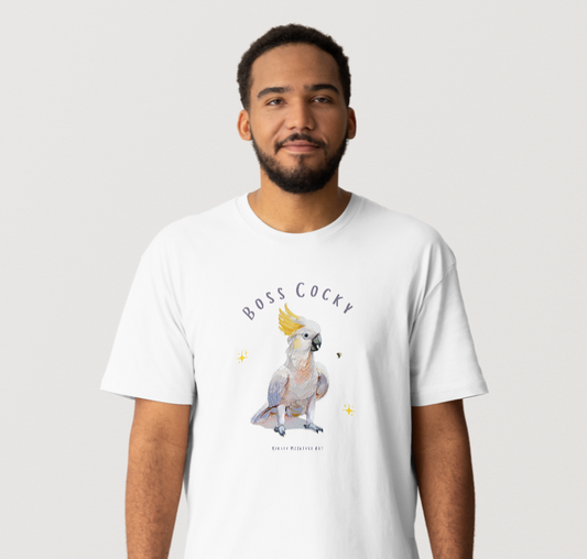 Man wearing a white t-shirt with a graphic of a cockatoo and text on a plain background; "Boss cocky" original design tshirt by bird lover and artist Kirsty McIntyre art
